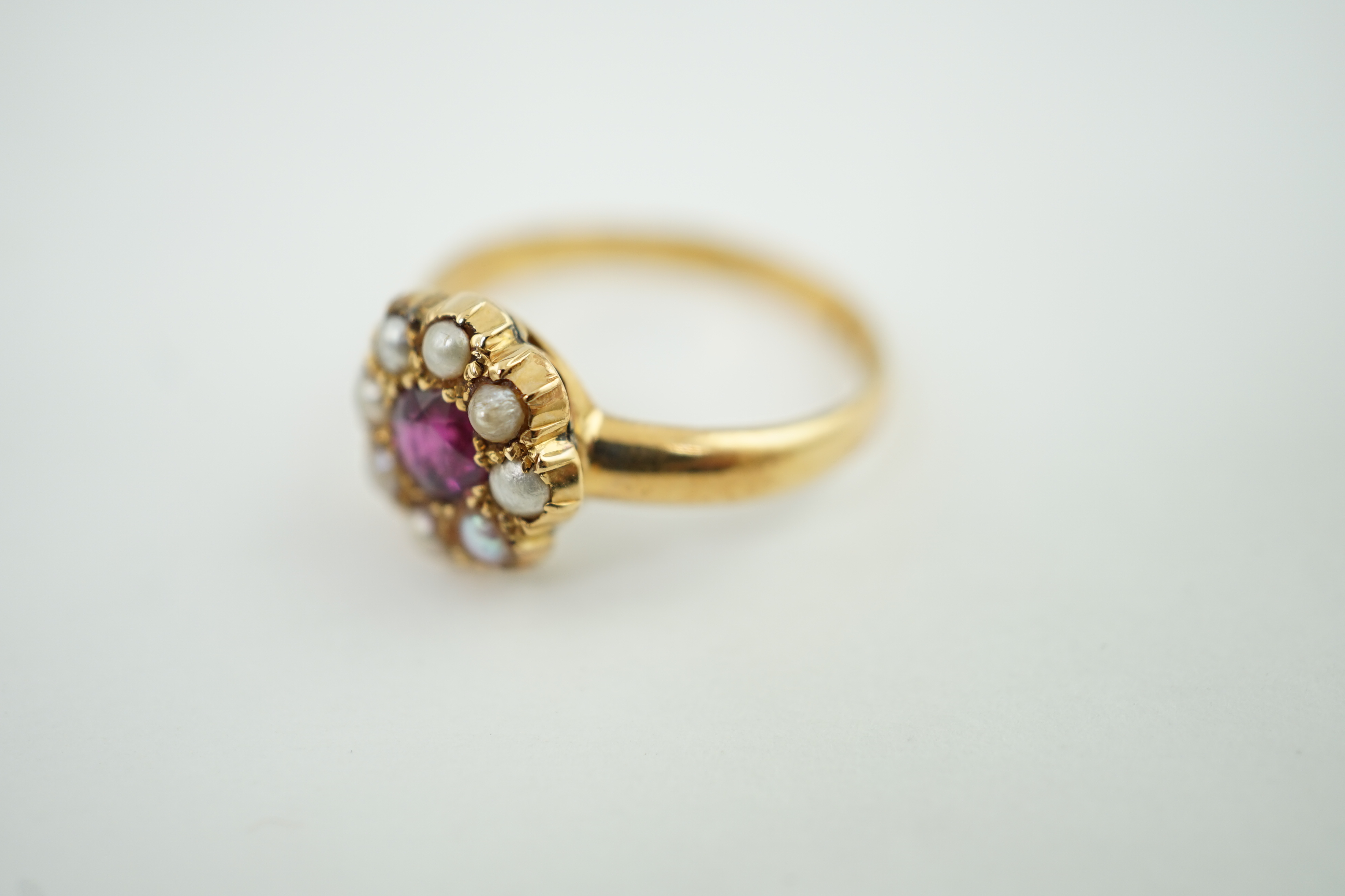 A gold, ruby and split pearl cluster ring